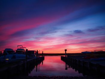 Pier over sea against sky during sunset