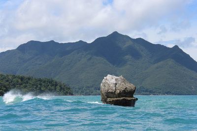 Scenic view of sea and mountains against sky