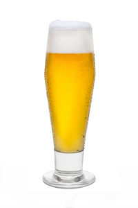 Close-up of beer glass against white background