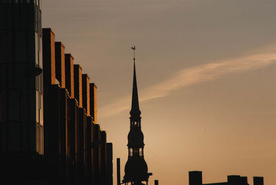 Low angle view of buildings against sky during sunset