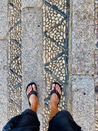 Low section of man standing on footpath