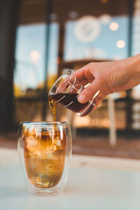 Cropped hand pouring water in glass