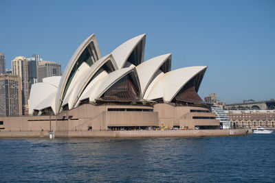 Buildings in city against clear sky