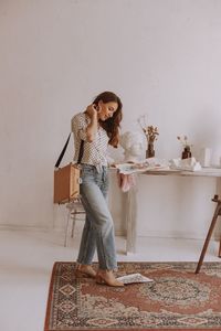 Portrait of young woman sitting on chair at home