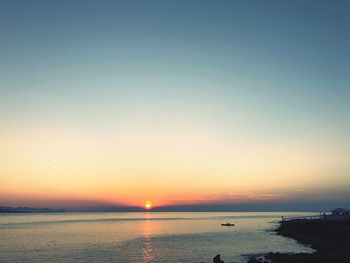 Scenic view of sea against clear sky during sunset