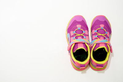 High angle view of multi colored shoes over white background