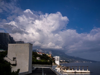 View of cityscape against cloudy sky