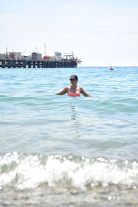 Young woman swimming in sea