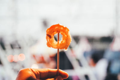 Close-up of hand holding orange