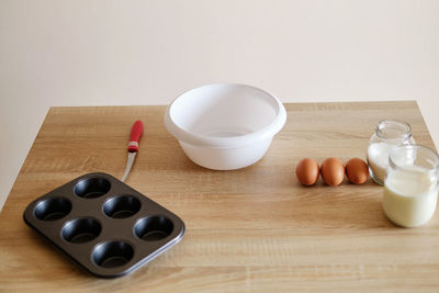 Cookware with baking ingredients plates and shapes waiting to cooked