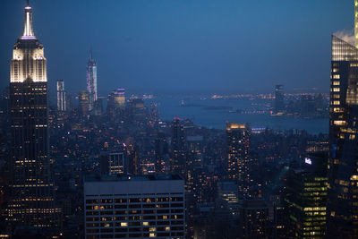 High angle view of buildings lit up at night