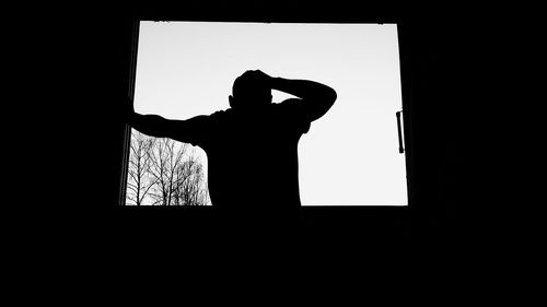 Silhouette man standing against clear sky