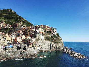 View of town by sea against clear sky