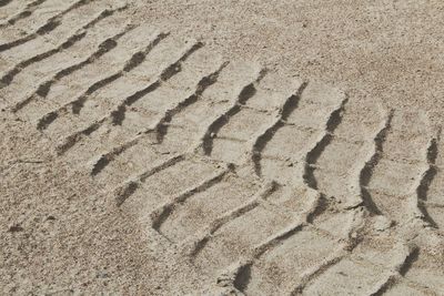 High angle view of footprints on sand at beach