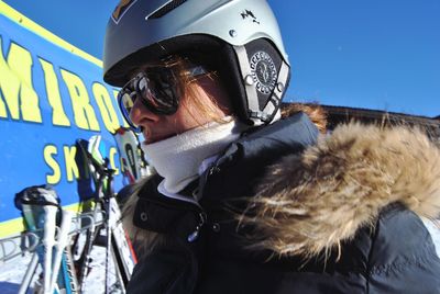 Close-up of woman in helmet and sunglasses during winter