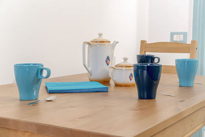 Close-up of coffee cups on breakfast table