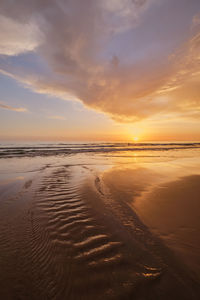 Scenic view of beach against sky during sunset