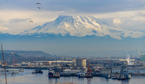 Mount rainier towers over the port of tacoma.