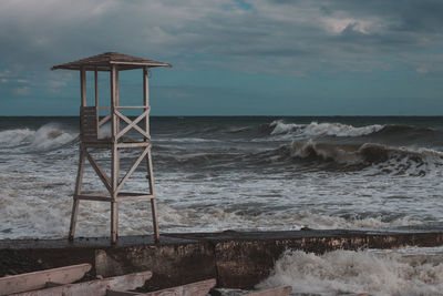 Lifeguard hut on beach against sky