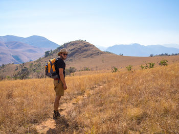 Full length of man standing on field against mountains