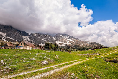 Scenic view of field and mountains against sky