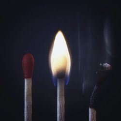 Close-up of illuminated lighting equipment against black background