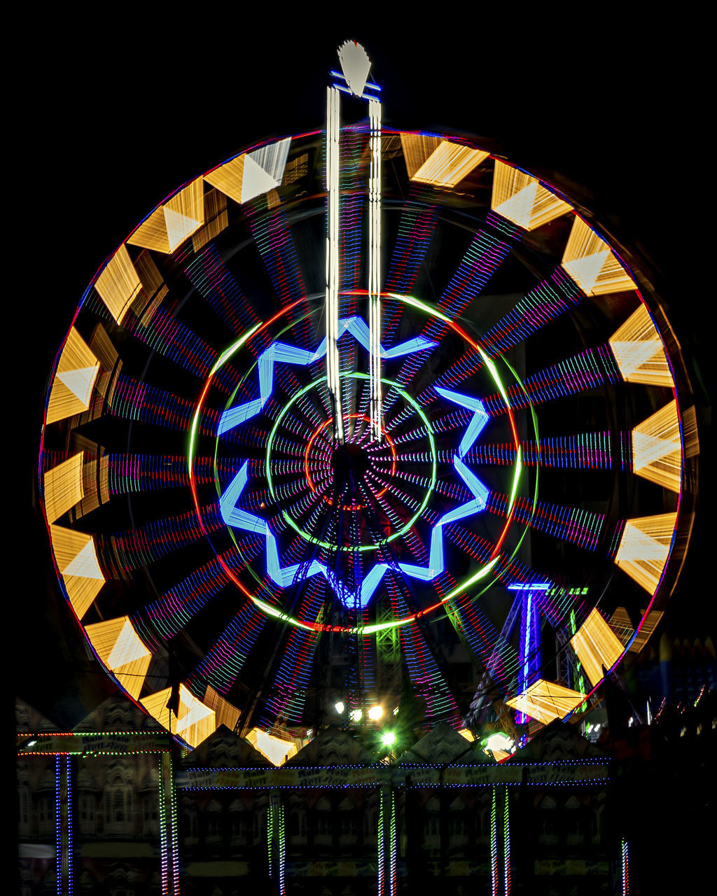 multi colored, amusement park ride, illuminated, amusement park, circle, night, geometric shape, arts culture and entertainment, architecture, ferris wheel, shape, no people, built structure, low angle view, glass, pattern, traveling carnival, carnival, window