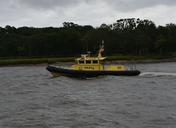 Boat in river against sky