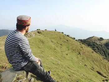 Man standing on mountain against clear sky