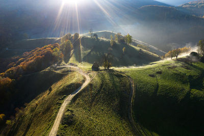 Aerial view of a mountain homestead in the autumn in early morning lights. transylvania, romania