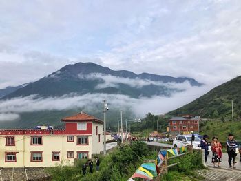 Buildings and mountains against sky