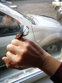 Close-up of hand holding car