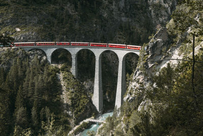 High angle view of train on landwasser viaduct by mountains