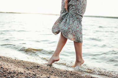 Low section of woman at beach