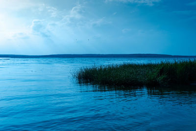 Scenic view of sea against blue sky