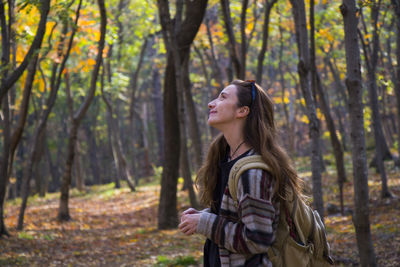 Beautiful woman in autumn and fall forest and wild, autumn tree with yellow and red leaves 