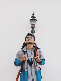 Portrait of young men standing against white background