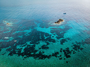 Drone shot of the sea near the shore. 