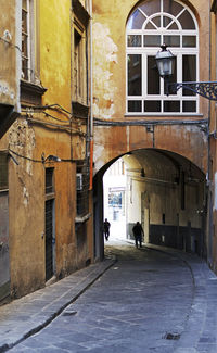 People walking on street amidst buildings in city