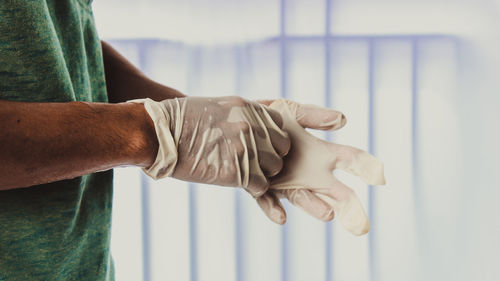 Close-up of man working against white wall