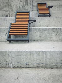 Empty bench against wall