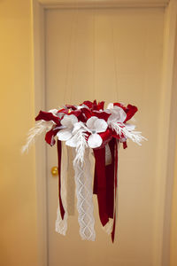 Close-up of red roses hanging on wall