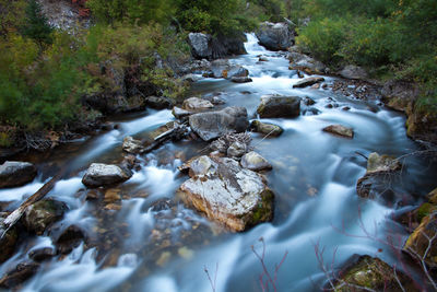 Scenic view of river flowing through rocks