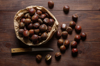 Topt view of autumn chestnuts on wooden table background