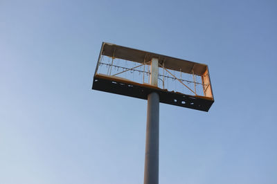 Low angle view of basketball hoop against clear blue sky