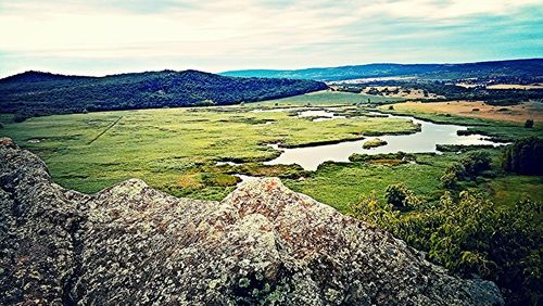 Scenic view of lake against cloudy sky