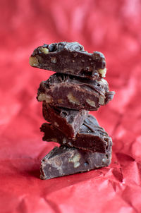 Close up of chocolate fudge triangles on a red background
