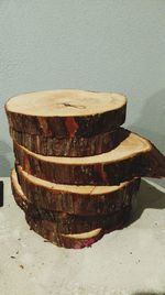 Close-up of rusty stack on table against wall