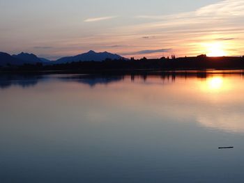 Scenic view of lake at sunset