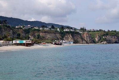 Scenic view of sea and buildings against sky